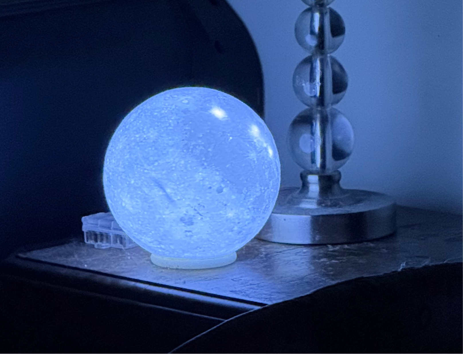 3D printed LED Moon ambiance lamp on an end table 