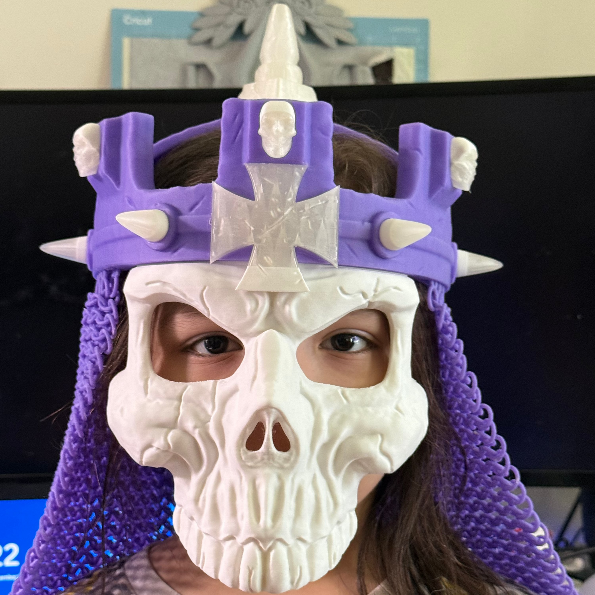 Person wearing the purple-and-white 3D printed WWE Skull King Crown with a skull mask.