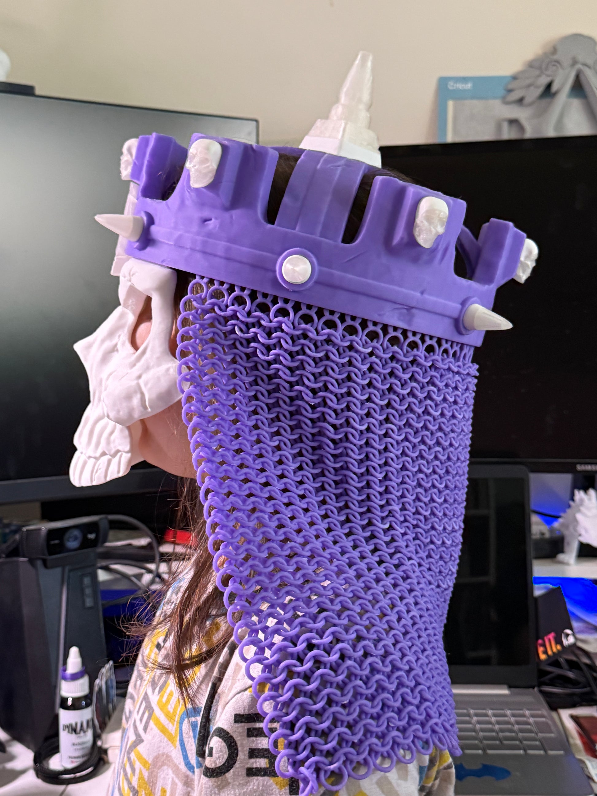 Left-side close-up of the purple 3D printed WWE Skull King Crown, white skull mask, and chainmail-style drape.