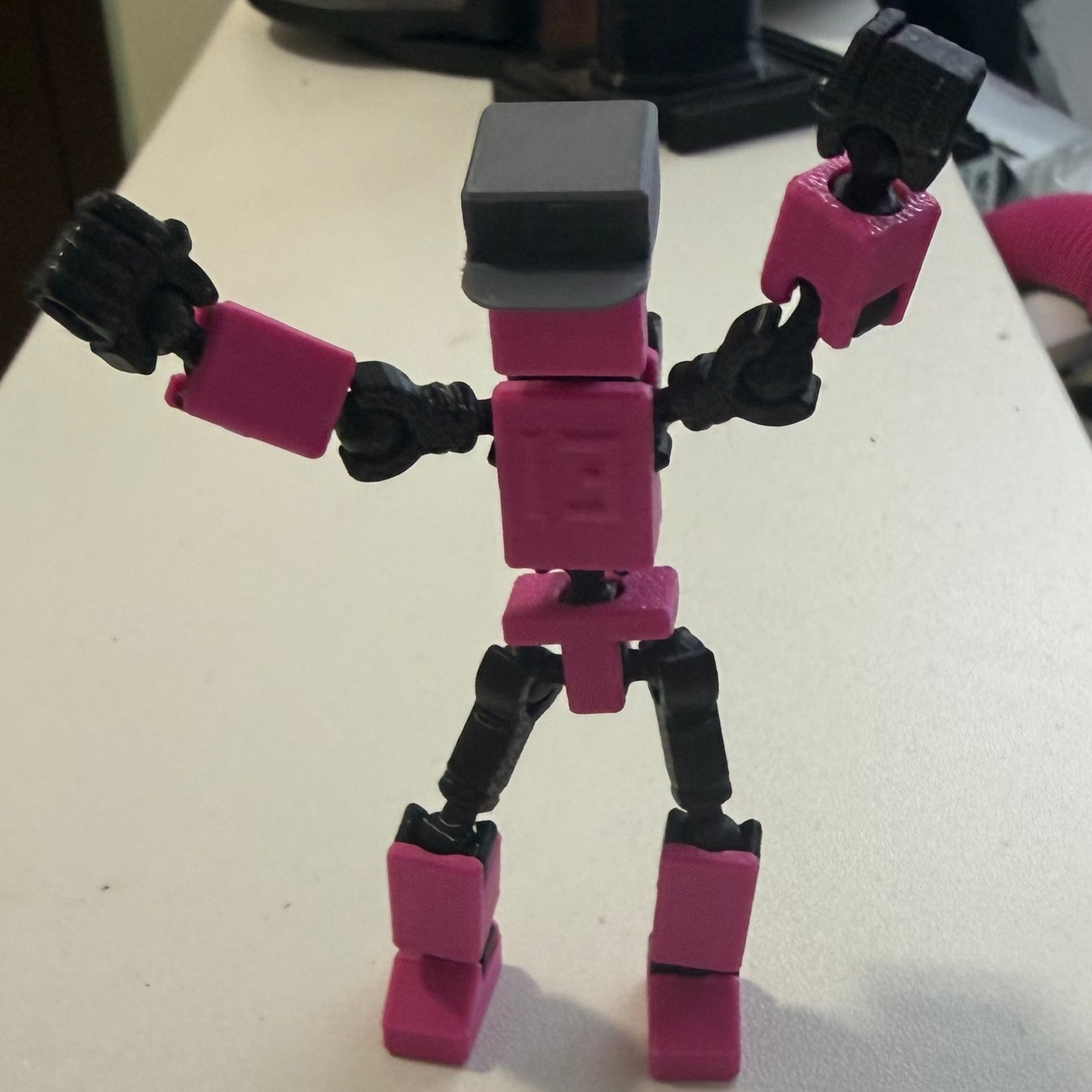 Toy figure on a white surface with a blurred background
