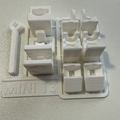 White plastic component with multiple parts on a white background