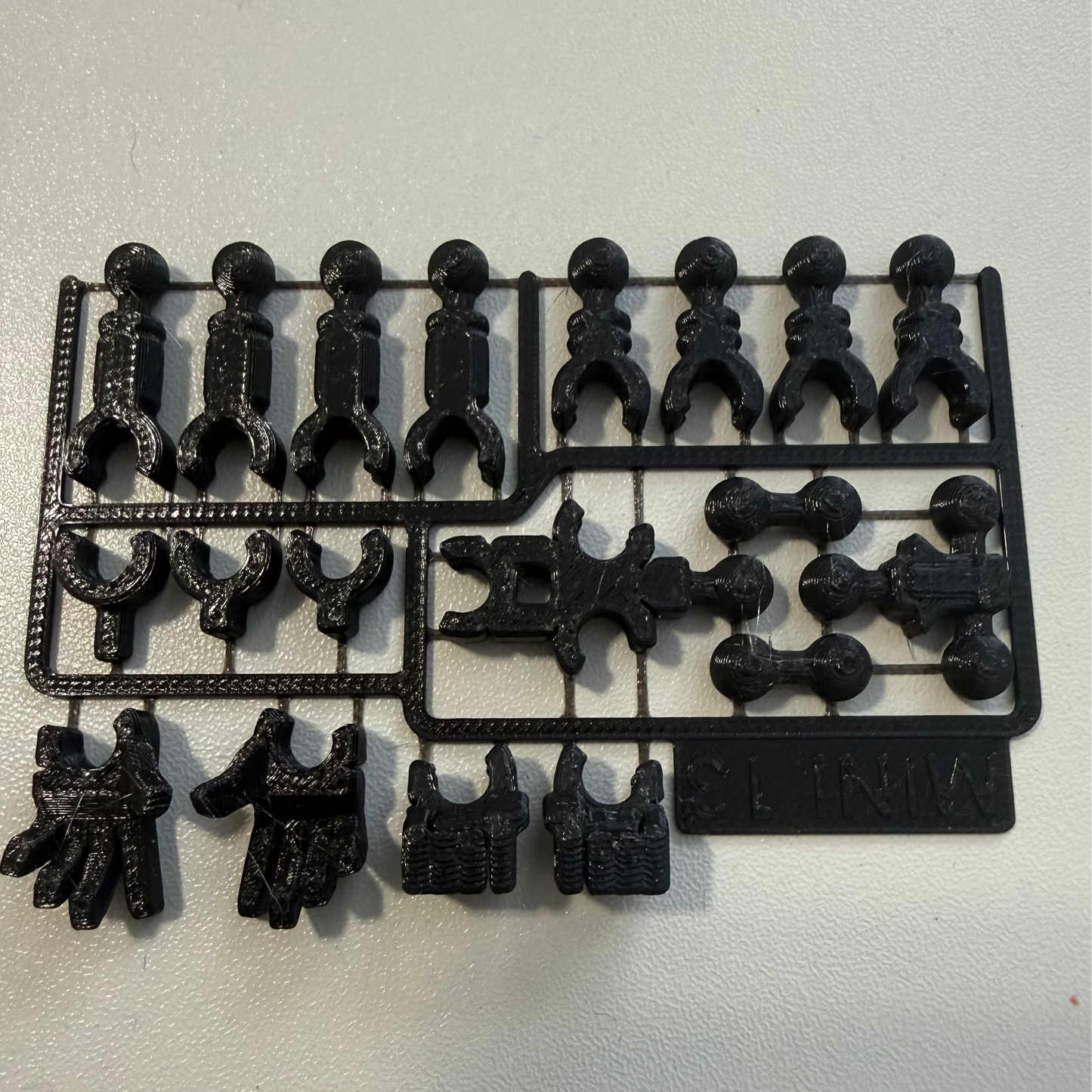 Black bracket with various components on a white background