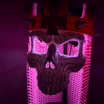 Close-up of the Skull King Crown and skull mask under purple-pink lighting, highlighting the sculpted skull detail and drape.