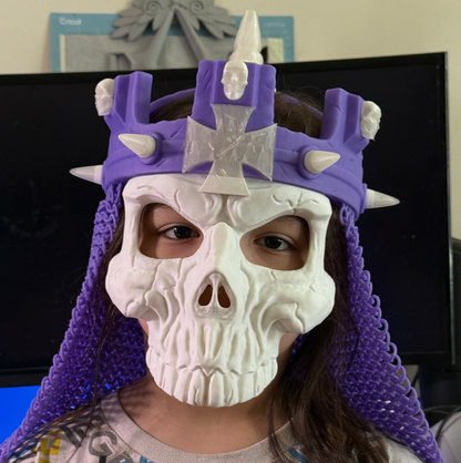 Front view of a person wearing the purple-and-white 3D printed WWE Skull King Crown with a skull mask.
