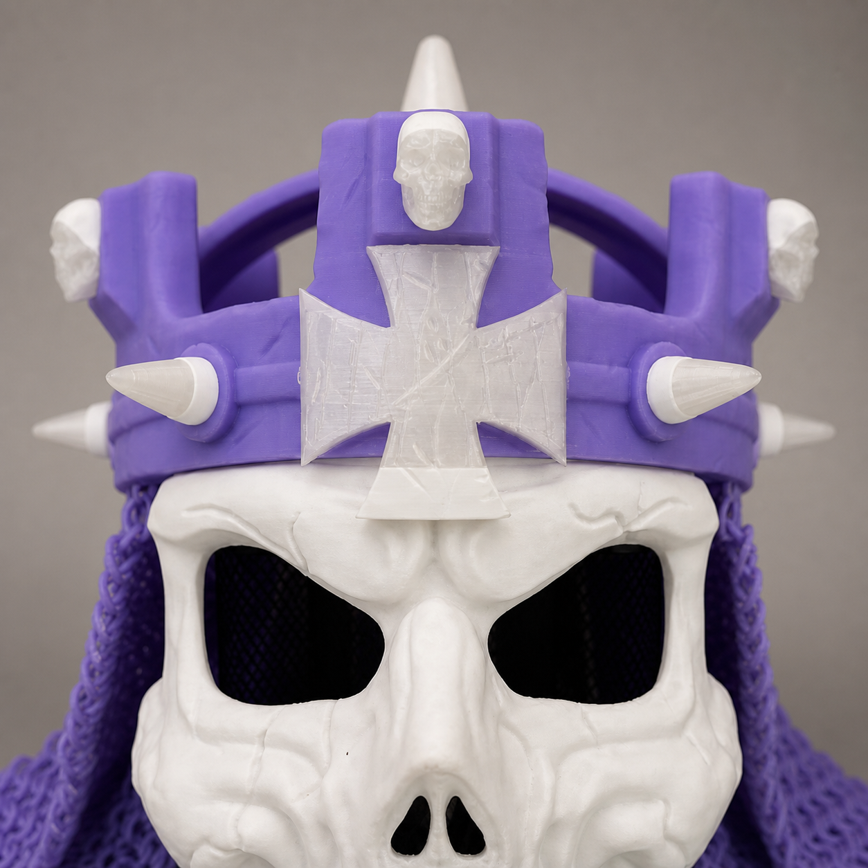 Studio close-up of the purple-and-white 3D printed WWE Skull King Crown showing the center emblem, front spikes, and sculpted skull-mask texture.