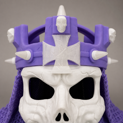 Studio close-up of the purple-and-white 3D printed WWE Skull King Crown showing the center emblem, front spikes, and sculpted skull-mask texture.