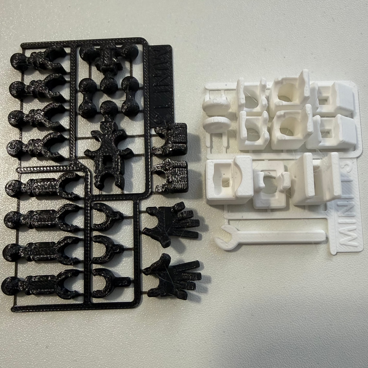 Black and white plastic parts on a gray background